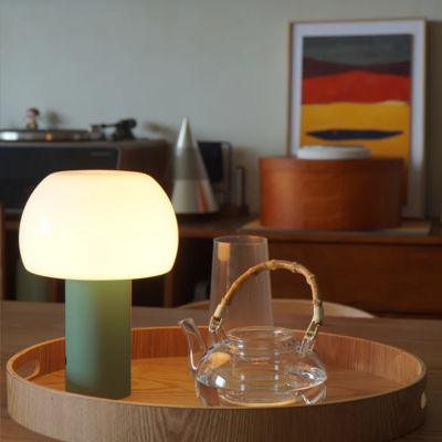 Lampe champignon vert sauge abat-jour-blanc sans fil rechargeable dans cabaret bois avec théière en verre dans salon moderne éclectique