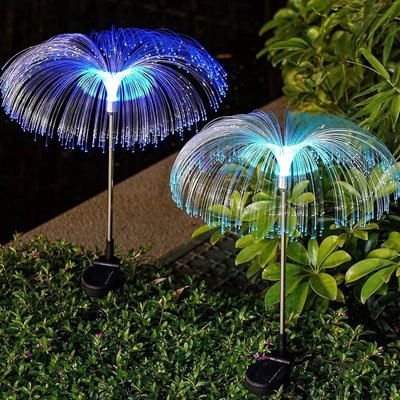 Lampe solaire extérieur méduse fibre optique multicolore bleu et violet plantées dans jardin la nuit, éclairage décoratif extérieur