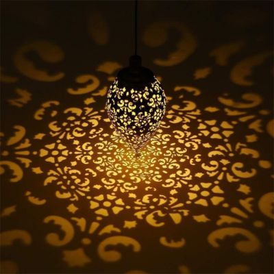 Lanterne solaire LED suspendue métal ajouré illuminant de jolies formes au sol